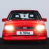 Head-on view of Vauxhall Nova Turbo with headlights on