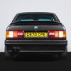 Rear view of the BMW E30 325i Sport with factory tail lights and spoiler