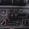 BMW E30 central dashboard showing radio and temperature controls