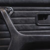 Close-up of BMW E30 black leather door card