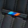 Close-up of E30 seat showing M Sport tricolour branding