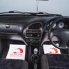 Wide shot of interior of white Citroen Saxo VTS Phase 2, including dash, seats, and classic hot hatch styling.