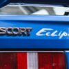 Rear branding showing Escort and Eclipse badges on the car