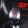 Close-up of gearstick with glowing ST logo in Ford Fiesta ST-2 Ecoboost – Redline Competitions