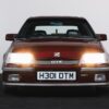 Front of 1990 Vauxhall Astra GTE Champion Edition with headlights on – Redline Competitions