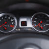 Close-up of Renault Clio 197 'Meglio' dashboard dials showing performance instrumentation – Redline Competitions