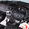 Driver point-of-view inside Renault Clio 197 'Meglio' showing steering wheel, dials, screen, and cash – Redline Competitions