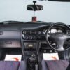 Wide angle interior of Ford Escort RS 2000 showing dashboard and cockpit.