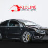 Black Ford Focus ST3 angled front side view with PI lowering springs, spacers, satin black roof wrap, Maxton rear spoiler lip, RS parts diffuser, and yellow brake calipers | Redline Competitions