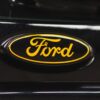 Close-up of yellow and black Ford badge on rear of black Focus ST3 | Redline Competitions
