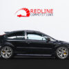 Side profile of black Ford Focus ST3 with PI lowering springs, spacers, facelift wing mirrors, RS parts diffuser, and yellow brake calipers | Redline Competitions