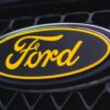 Close-up of yellow and black Ford badge on front of black Focus ST3 | Redline Competitions