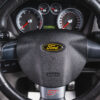 Close-up of steering wheel in black Ford Focus ST3 with ST branding | Redline Competitions
