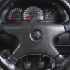 Astra GSI C20LET Turbo steering wheel with dials in background.