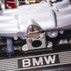 BMW E30 M-tech II red close-up of engine showing BMW branding on cover – Redline Competitions