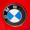 BMW E30 M-tech II red close-up of front BMW badge – Redline Competitions