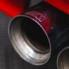 BMW E30 M-tech II red close-up of M-branded exhaust tip – Redline Competitions