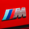 BMW E30 M-tech II red close-up of M badge on rear – Redline Competitions
