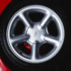 Cosworth alloy wheel close-up on Ford Sierra Sapphire Radiant Red UK competition car.