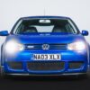 Front of the Volkswagen Golf R32 Mk4 with headlights turned on – Redline Competitions