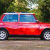 Side profile of the 1996 Mini Cooper 1.3 SPi in red with Union Jack roof at Redline Competitions