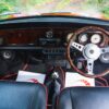 Interior of the 1996 Mini Cooper 1.3 SPi showing leather seats, red trim, and walnut dash at Redline Competitions