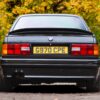 Rear angle of BMW E30 325i Sport MTech II kit in black from Redline Competitions